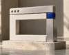Sculptural browser window made from ivory blocks with a cobalt-blue connector, illustrating website maintenance.